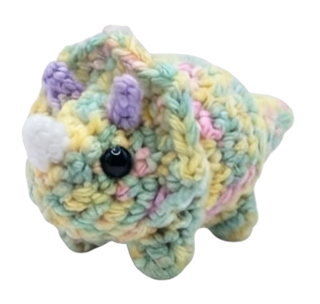 A regular-size pastel rainbow triceratops plush