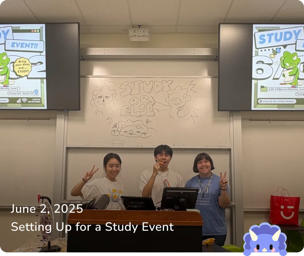 June 2, 2025 — Setting Up for a Study Event: three members at the check-in desk under STUDY OR ELSE whiteboard art.