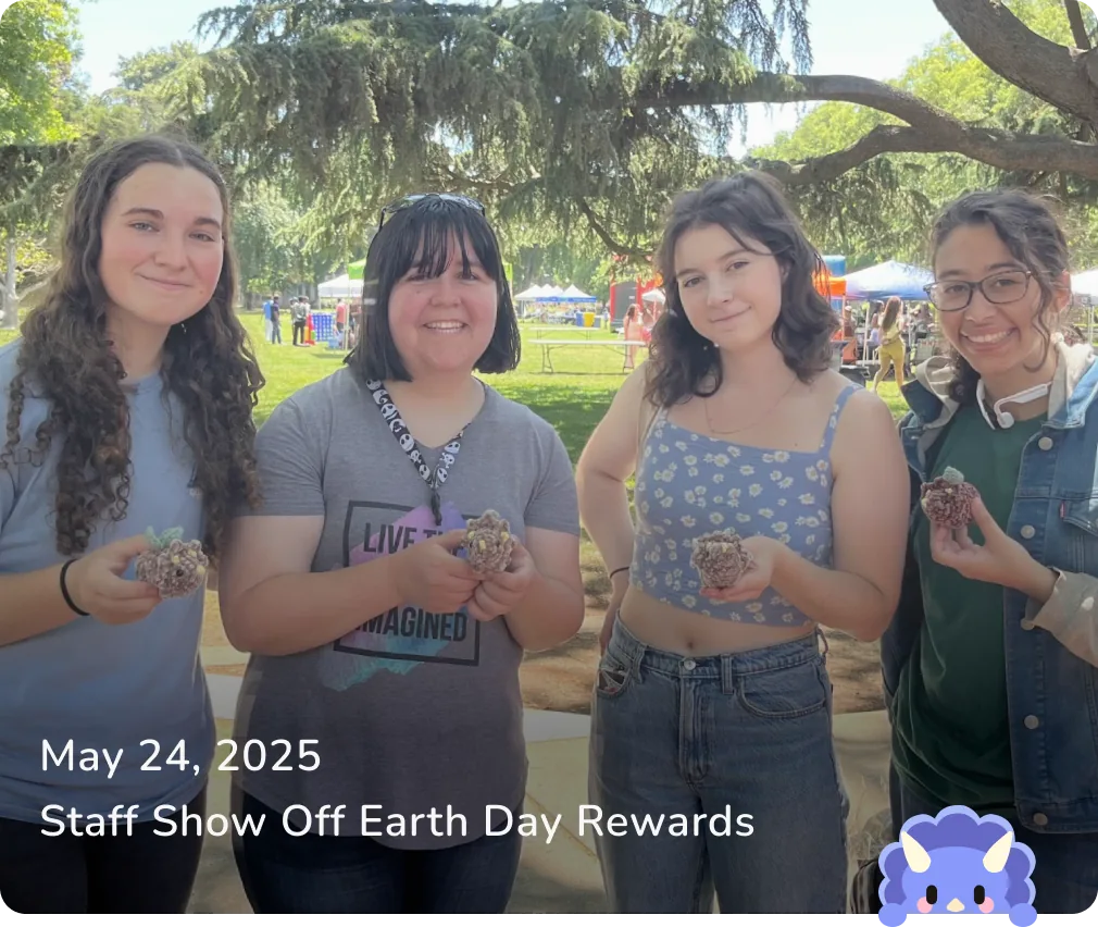 May 24, 2025 — Staff Show Off Earth Day Rewards: four members holding crocheted dinos outdoors.