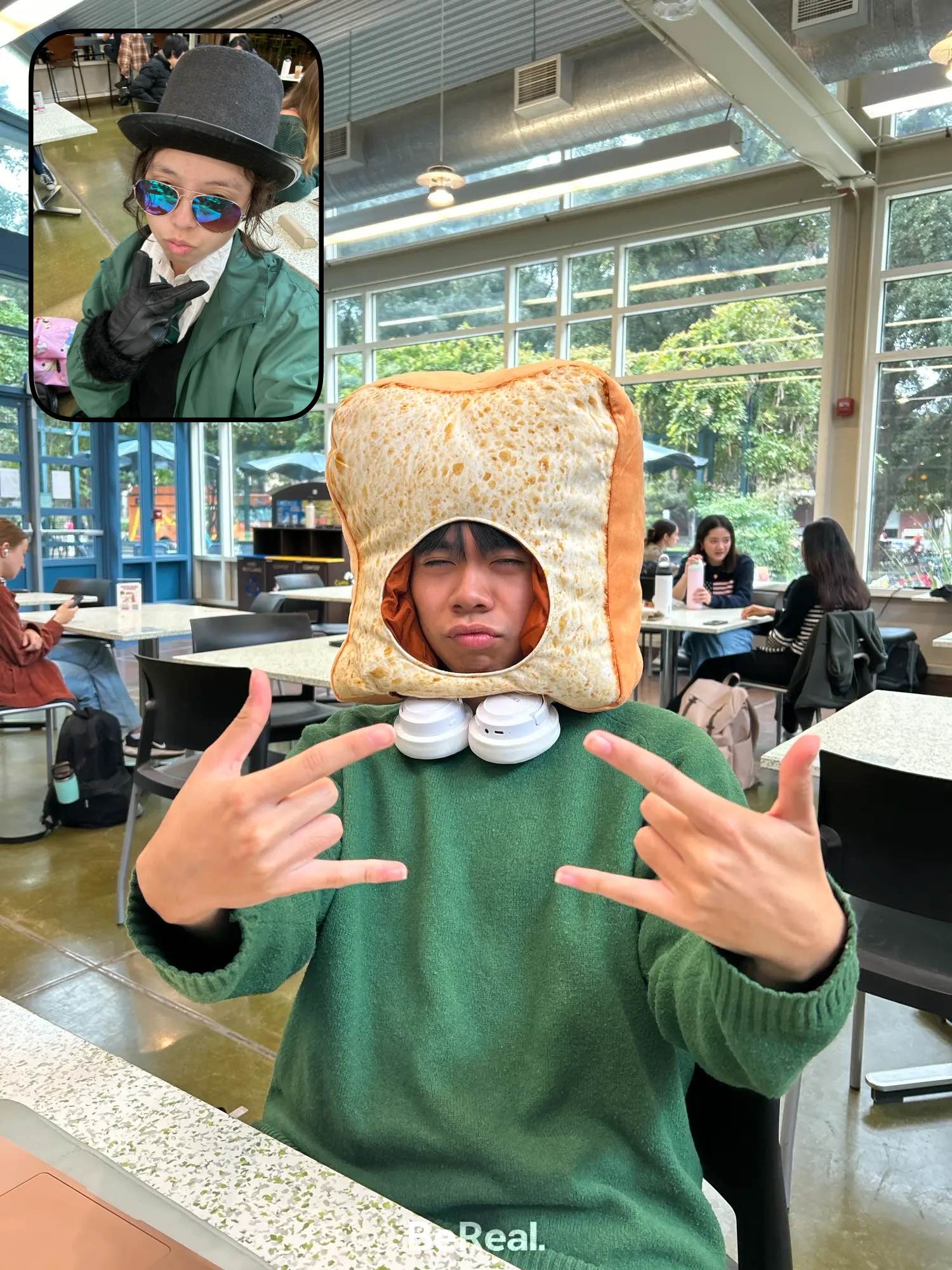 A member wearing a toast-shaped hat making a silly face